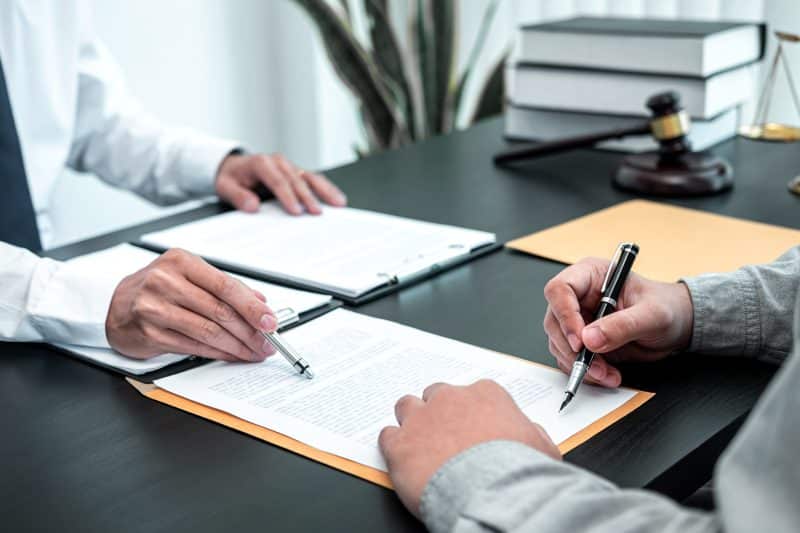 An experienced Social Security Disability claims attorney helps a client navigate the details of a case.