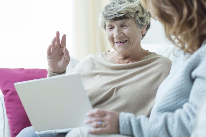 Daughter Teaching Mom To Use A Laptop Computer