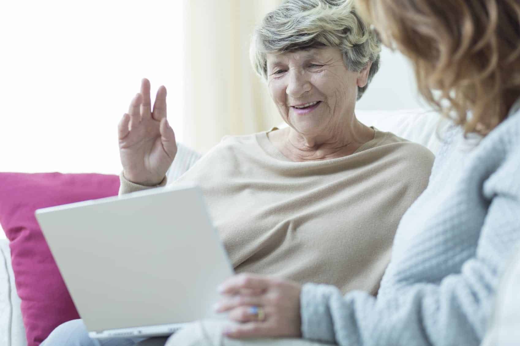 Daughter Teaching Mom To Use A Laptop Computer