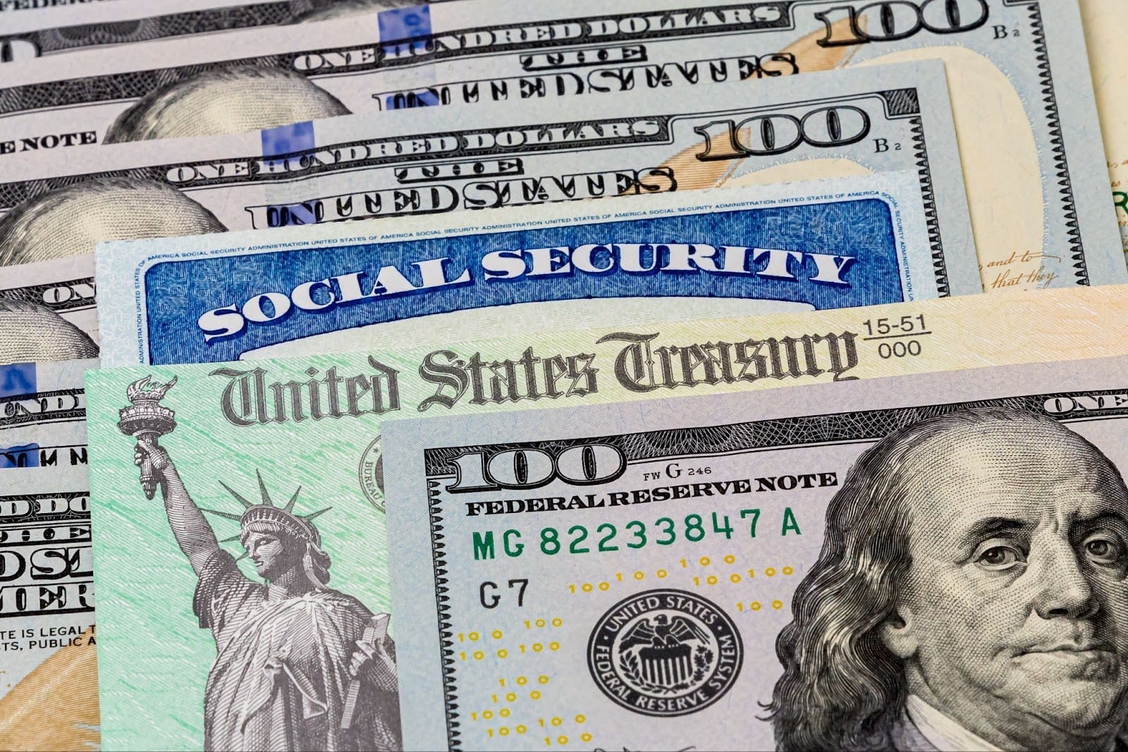 A $100 bill on top of a United States Treasury Bill Note and Social Security Card